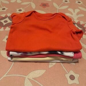 Lot of 4 Primary onesies (3-6 months) and one tie dye Carter’s (3 months)